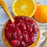 A bowl of homemade healthy cranberry sauce with fresh ginger and orange, refined sugar-free