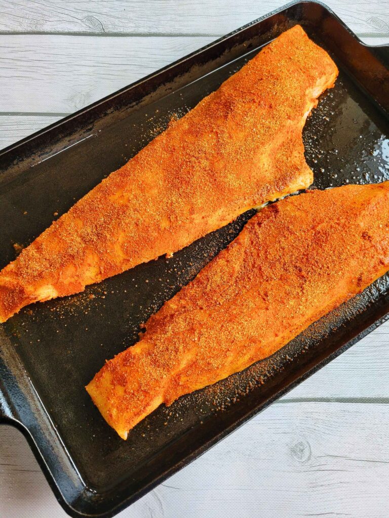 anti-inflammatory whitefish spice rub on cod fillets on a cast iron baking sheet